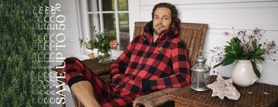 man sitting on a porch wearing a flannel onesie.